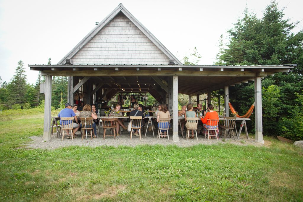 dinner at smithereen farm timber frame kitchen by Rinne Allen
